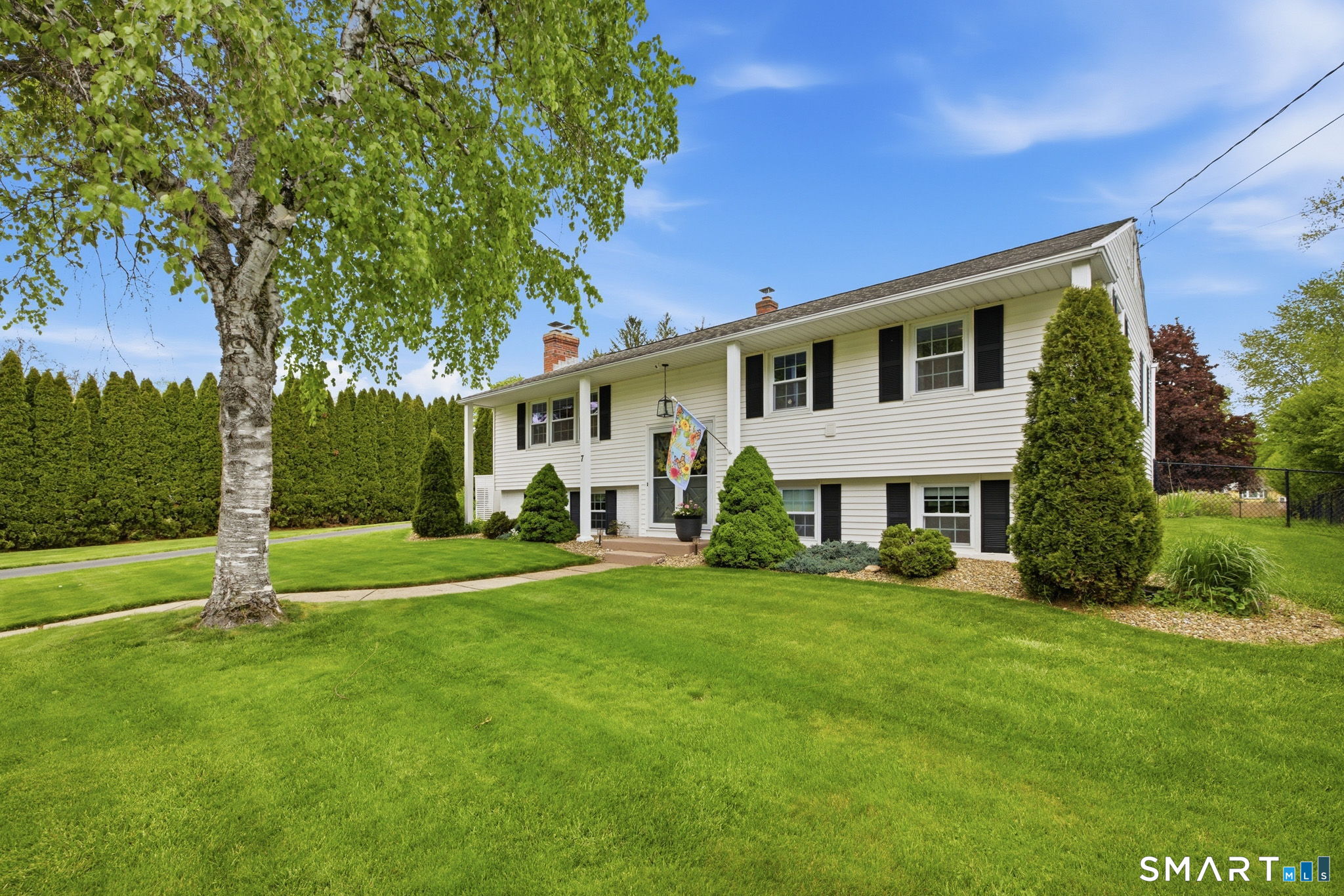 7 Stardust Drive Enfield, CT 06082 - Photo 37 of 38 a front view of a house with a garden