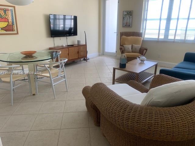 100 Lincoln Road, Unit 1434 Miami Beach, FL 33139 - Photo 3 of 29 a living room with furniture and a flat screen tv