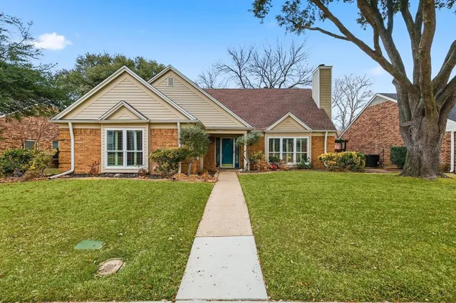 a front view of a house with a garden and porch