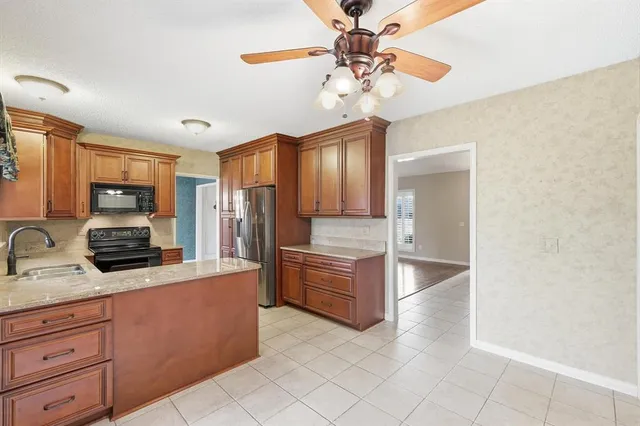 a kitchen with stainless steel appliances a sink cabinets and wooden floor