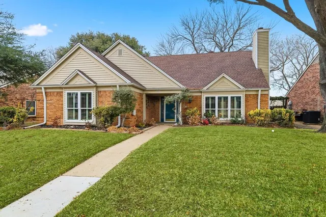 a front view of a house with a yard and porch