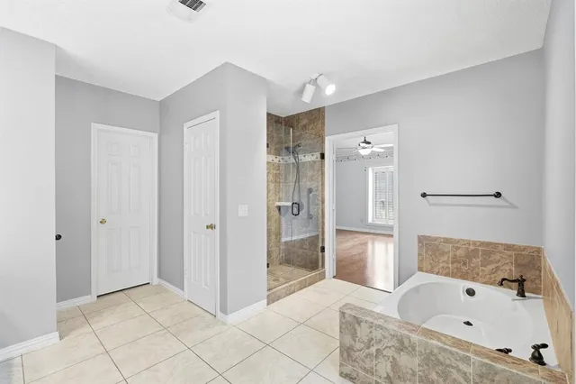 a bathroom with a bathtub and a shower