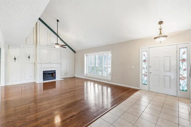 a view of a livingroom with wooden floor and a fireplace