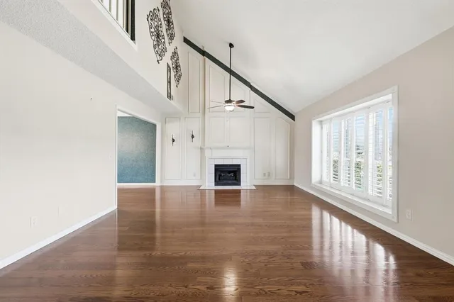 a view of a livingroom with wooden floor and fireplace