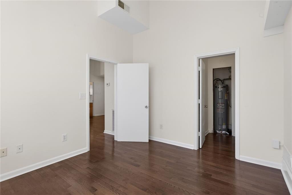 1031 State Street Northwest, Unit 205 Atlanta, GA 30318 - Photo 12 of 29 an empty room with wooden floor and closet