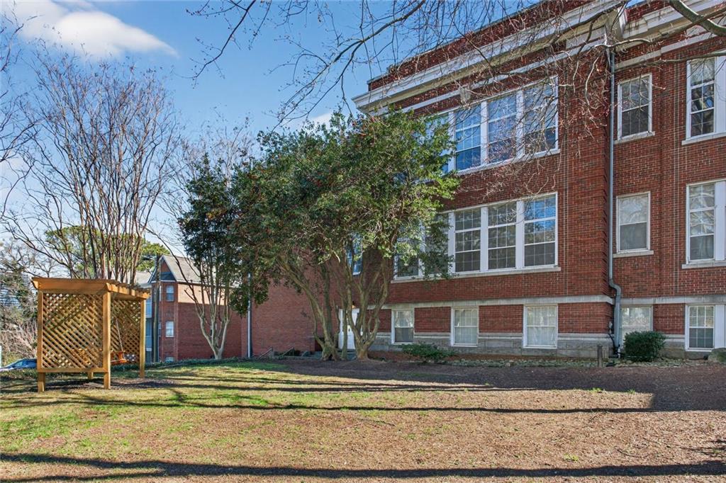 1031 State Street Northwest, Unit 205 Atlanta, GA 30318 - Photo 18 of 29 a view of a house with a yard in front of it