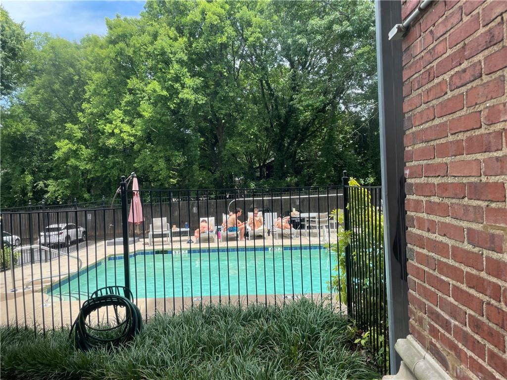 1031 State Street Northwest, Unit 205 Atlanta, GA 30318 - Photo 20 of 29 a view of a chair and table in the back yard of the house
