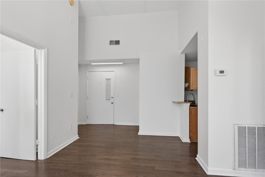 1031 State Street Northwest, Unit 205 Atlanta, GA 30318 - Photo 2 of 29 a view of an empty room with wooden floor