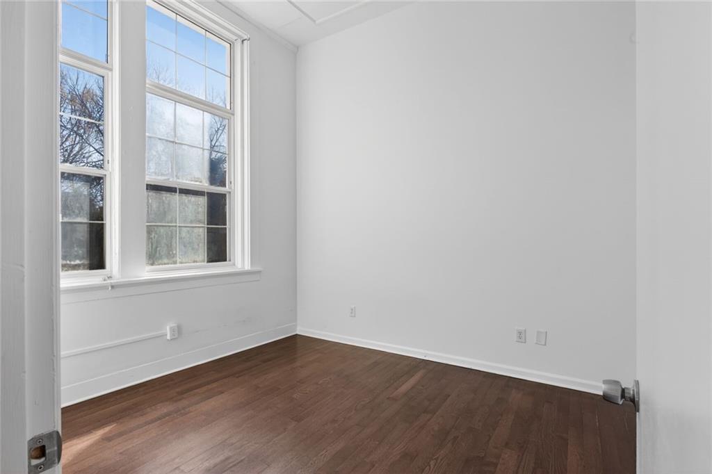 1031 State Street Northwest, Unit 205 Atlanta, GA 30318 - Photo 25 of 29 a view of an empty room with wooden floor and a window