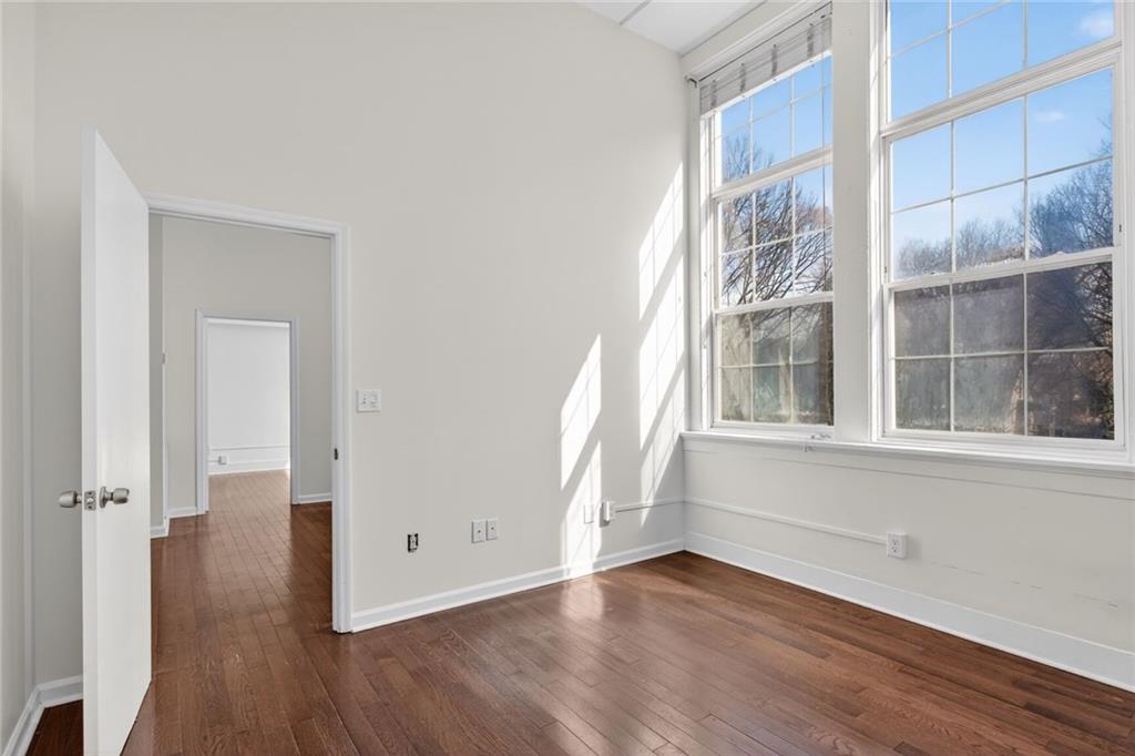 1031 State Street Northwest, Unit 205 Atlanta, GA 30318 - Photo 26 of 29 an empty room with wooden floor and windows