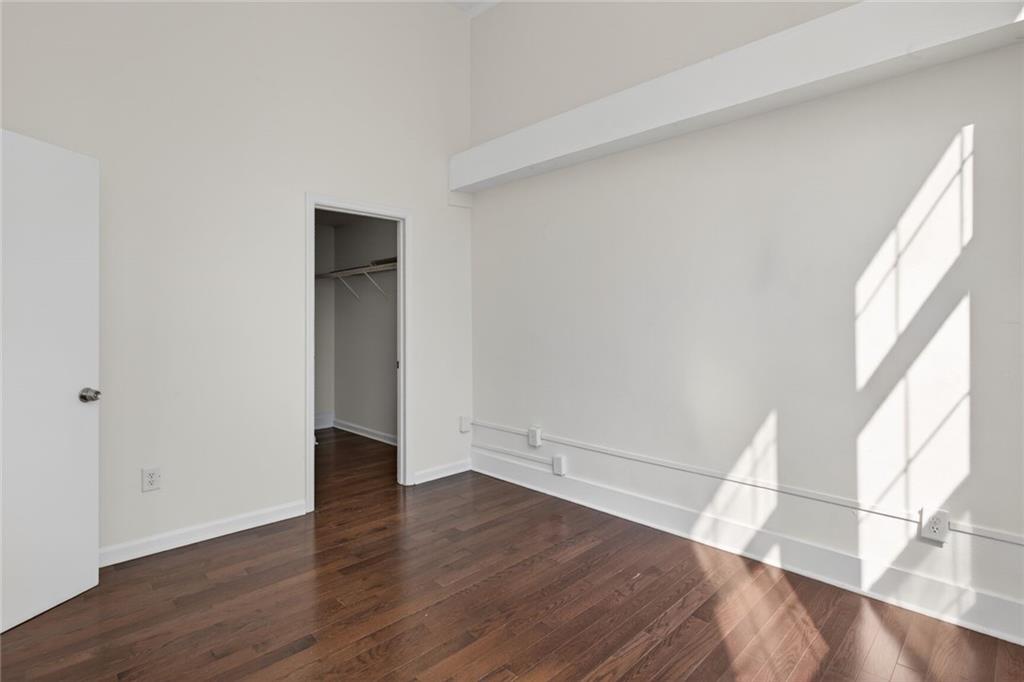 1031 State Street Northwest, Unit 205 Atlanta, GA 30318 - Photo 27 of 29 an empty room with wooden floor and windows
