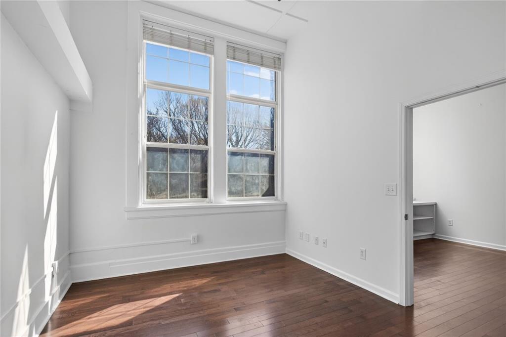 1031 State Street Northwest, Unit 205 Atlanta, GA 30318 - Photo 28 of 29 an empty room with wooden floor and a window
