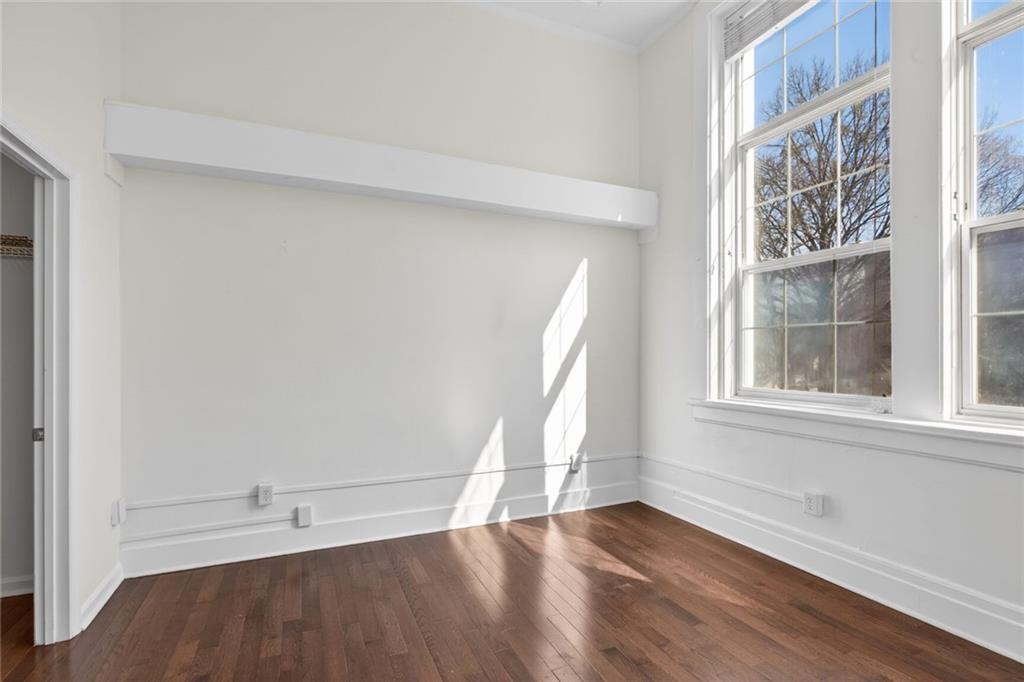 1031 State Street Northwest, Unit 205 Atlanta, GA 30318 - Photo 29 of 29 an empty room with wooden floor and windows