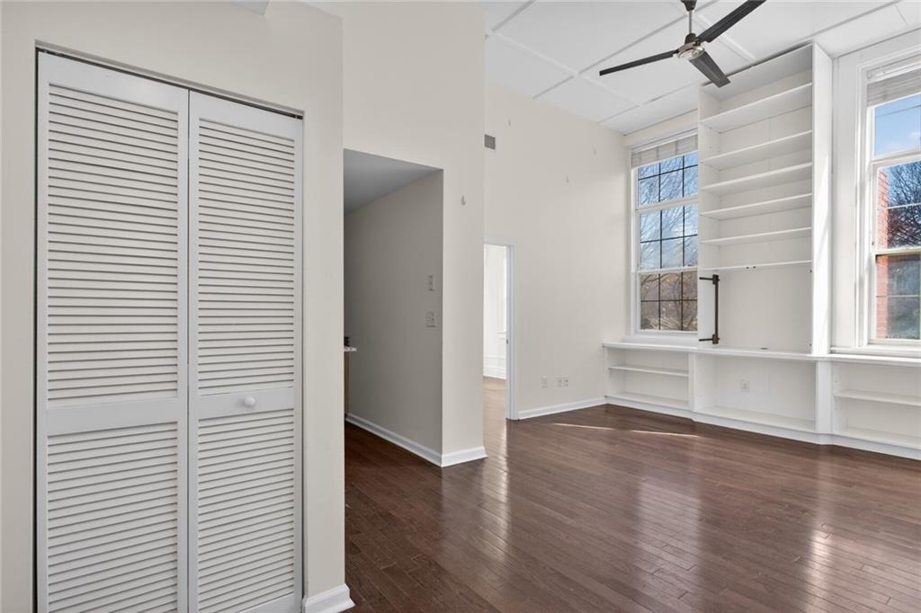 1031 State Street Northwest, Unit 205 Atlanta, GA 30318 - Photo 7 of 29 an empty room with wooden floor and windows