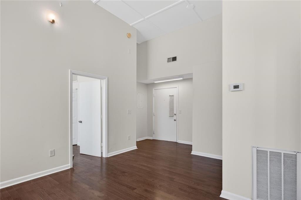 1031 State Street Northwest, Unit 205 Atlanta, GA 30318 - Photo 8 of 29 wooden floor in an empty room