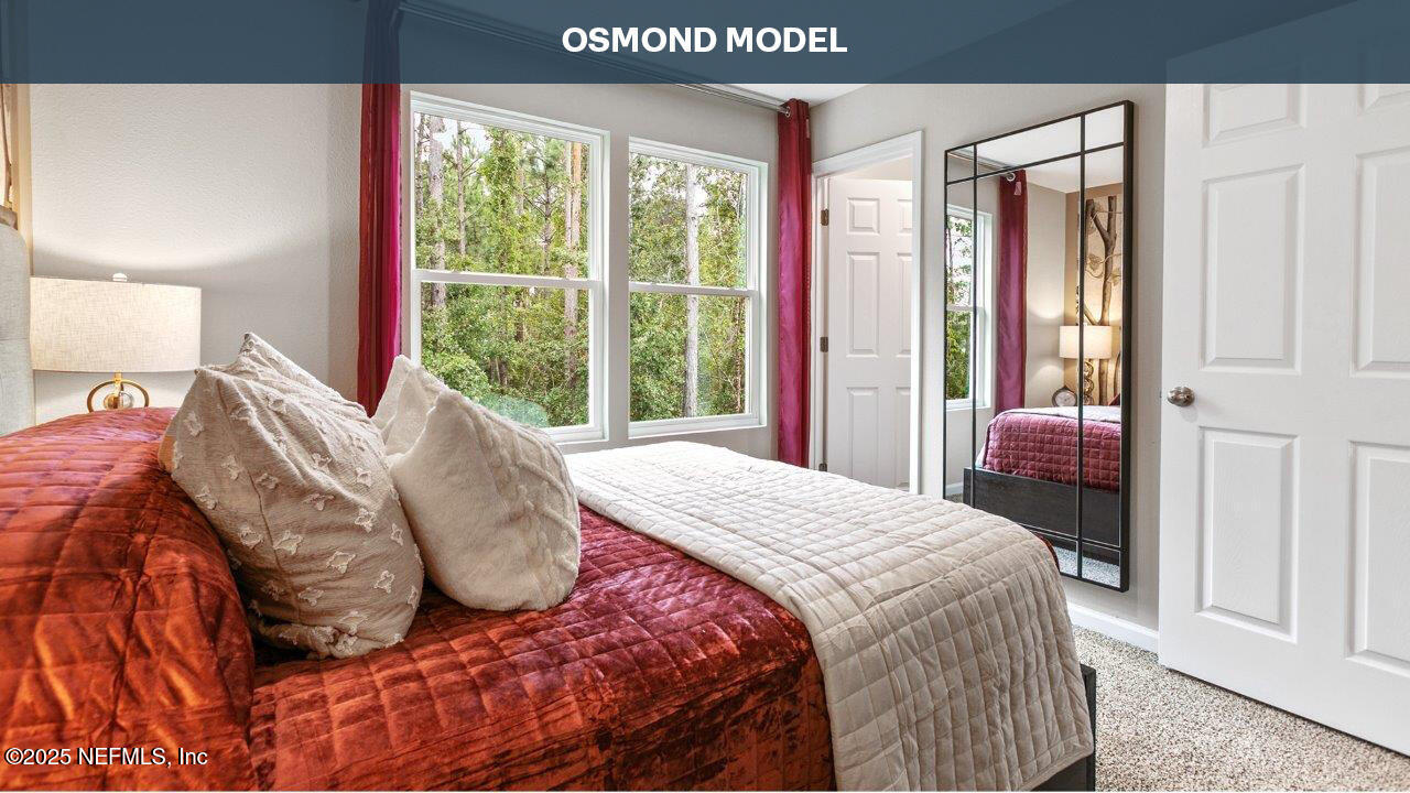 52 Montellano Road St. Augustine, FL 32084 - Photo 19 of 35 a bedroom with a bed and a large window