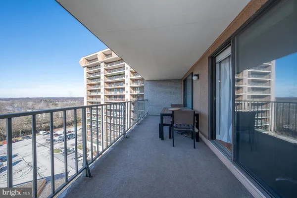 a balcony with chairs and a table