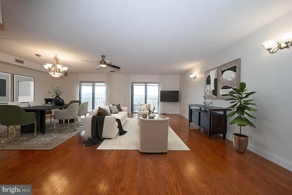 a living room with fireplace furniture and a wooden floor