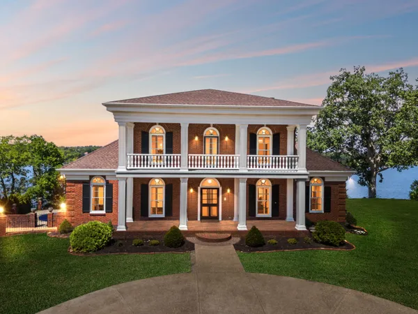 front view of brick house with a yard