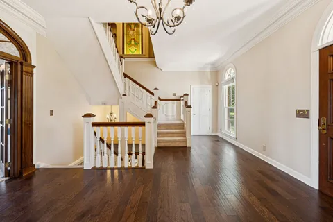 a living room with furniture large window and fireplace