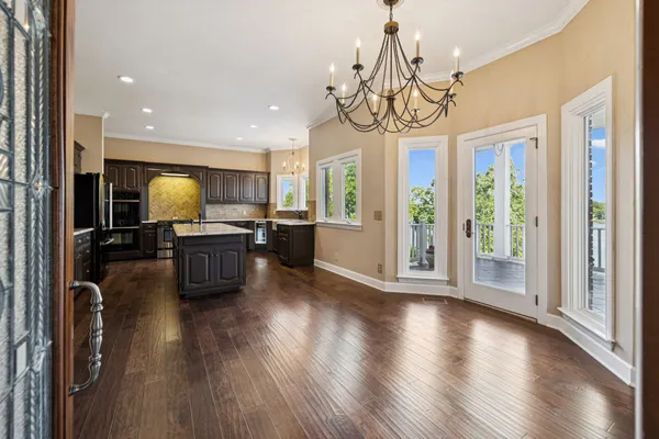 a living room with furniture large window and fireplace