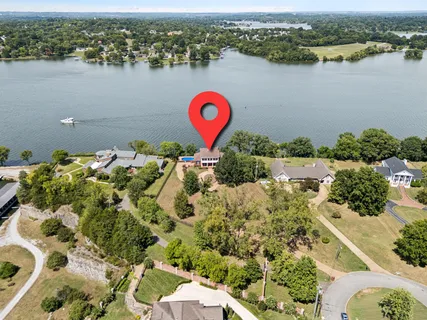 a view of a livingroom with furniture wooden floor windows and a chandelier