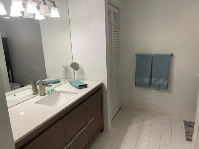 a bathroom with a sink a vanity and a mirror