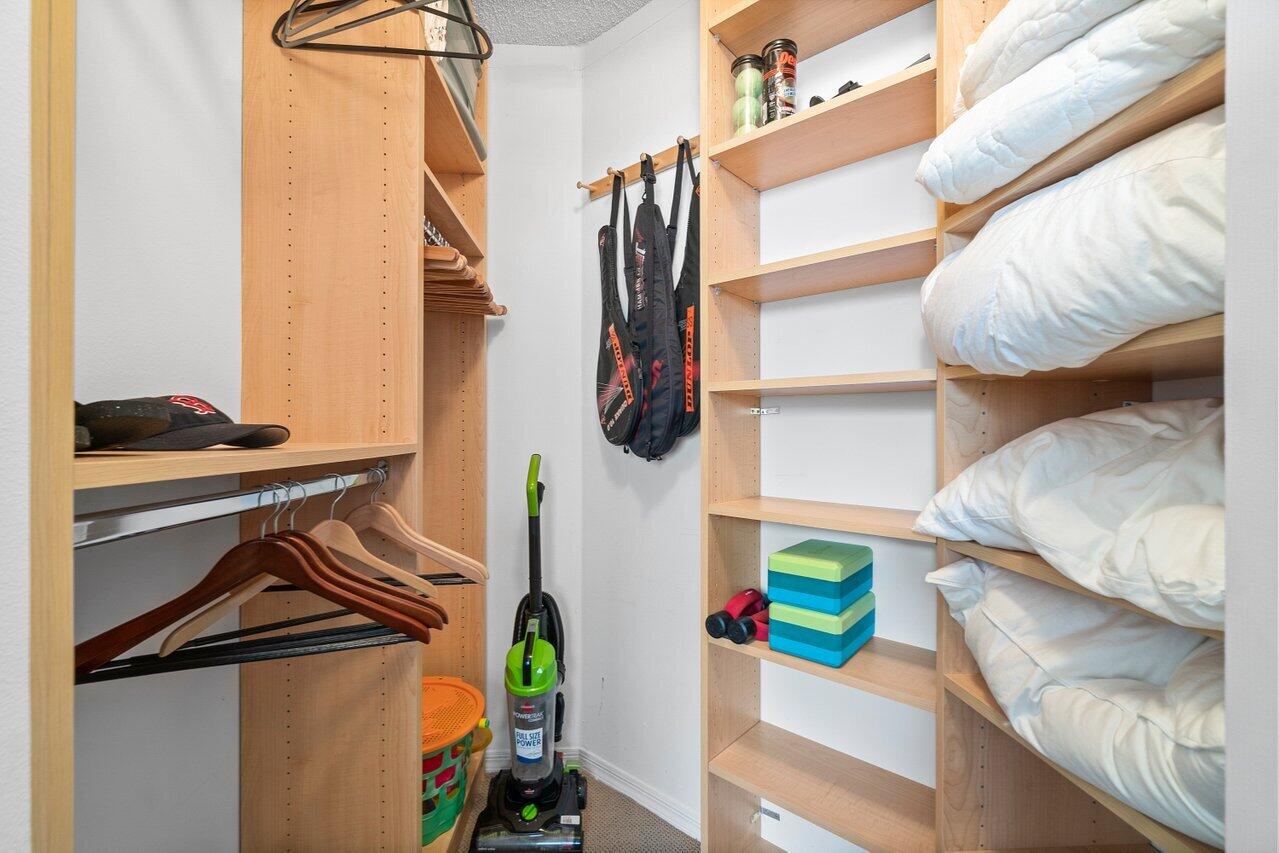 3594 South Ocean Boulevard, Unit 205 Highland Beach, FL 33487 - Photo 21 of 44 a view of walk in closet with clothes and shoes