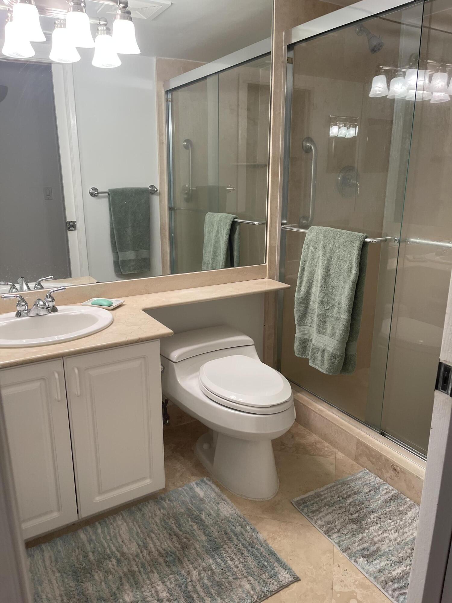 3594 South Ocean Boulevard, Unit 205 Highland Beach, FL 33487 - Photo 22 of 44 a bathroom with a sink a toilet and shower
