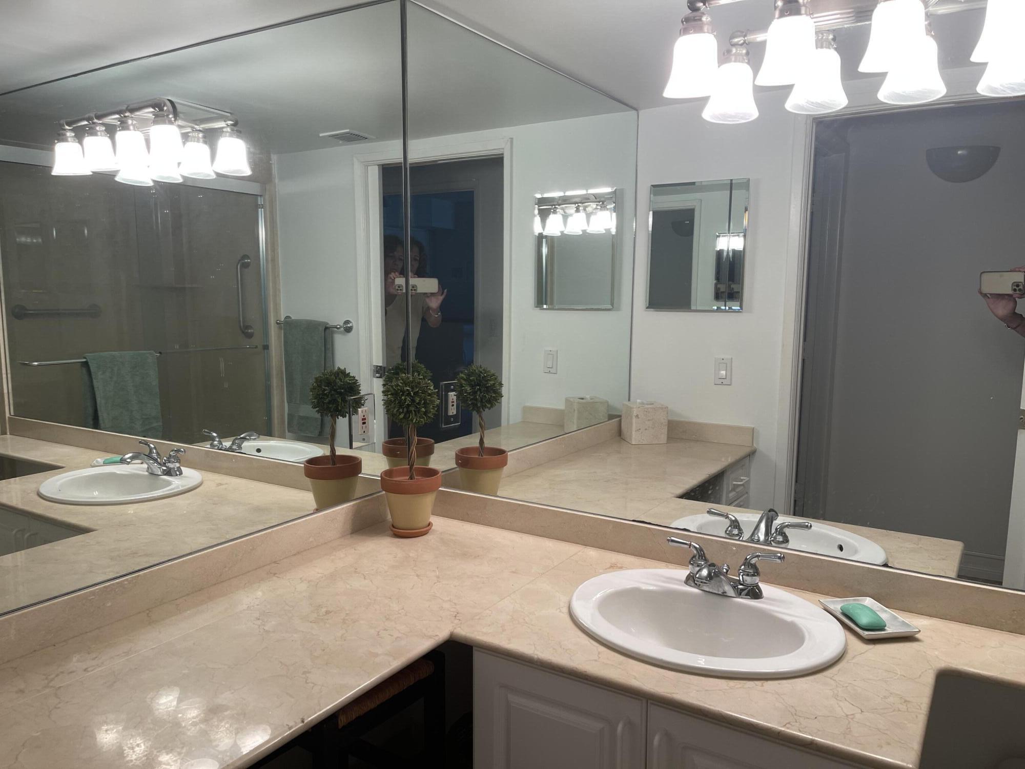 3594 South Ocean Boulevard, Unit 205 Highland Beach, FL 33487 - Photo 23 of 44 a bathroom with a sink and a mirror