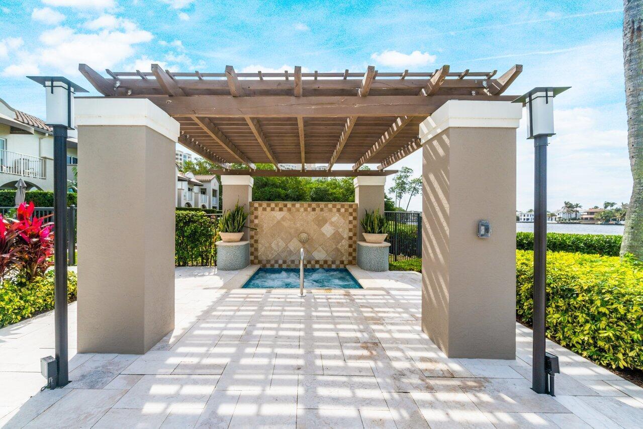 3594 South Ocean Boulevard, Unit 205 Highland Beach, FL 33487 - Photo 31 of 44 a view of a patio with table and chairs potted plants
