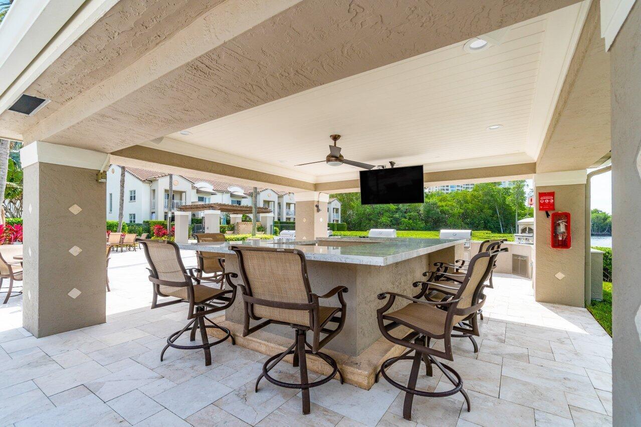 3594 South Ocean Boulevard, Unit 205 Highland Beach, FL 33487 - Photo 33 of 44 a view of a dining room with furniture and outdoor space