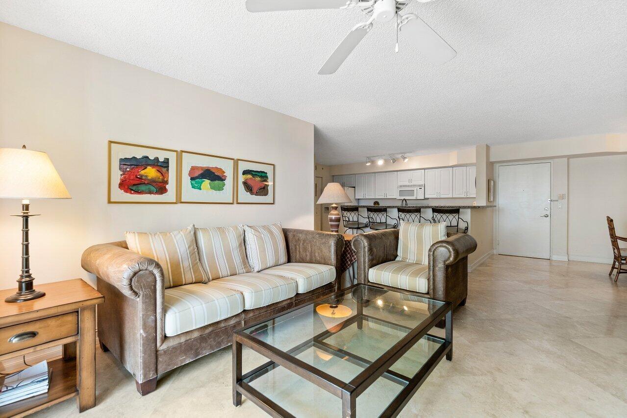 3594 South Ocean Boulevard, Unit 205 Highland Beach, FL 33487 - Photo 6 of 44 a living room with furniture and a kitchen view