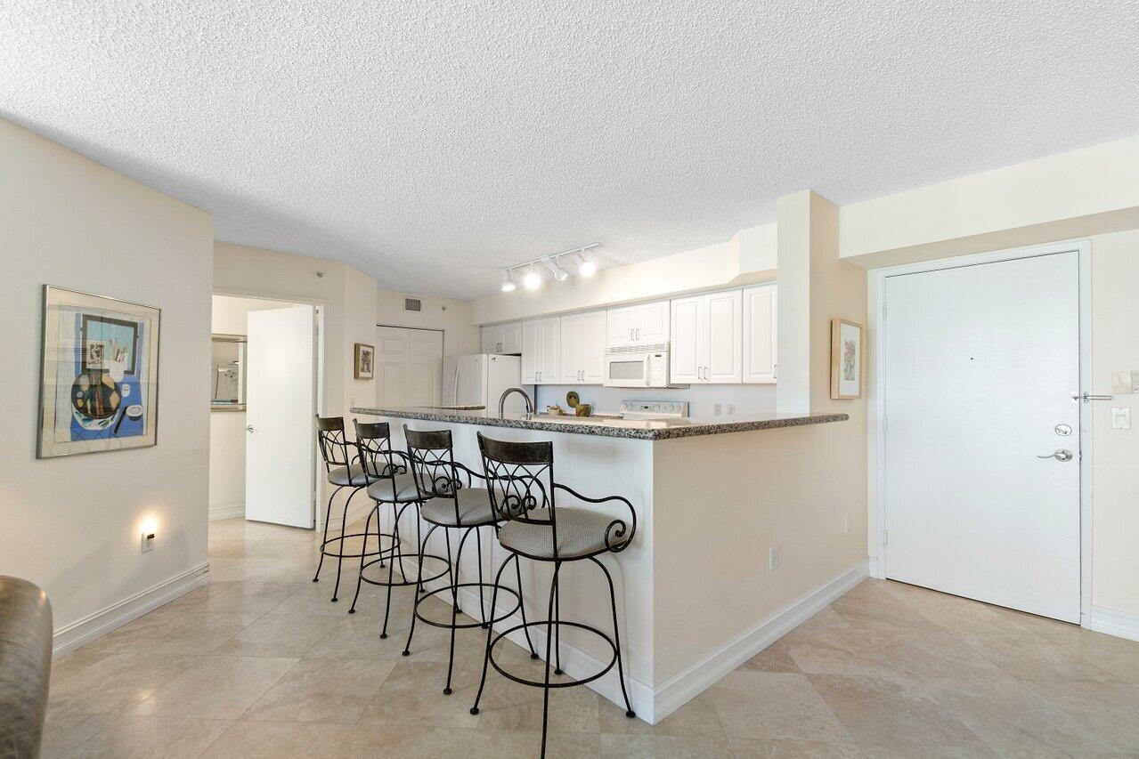 3594 South Ocean Boulevard, Unit 205 Highland Beach, FL 33487 - Photo 8 of 44 a view of a dining room with furniture and kitchen view