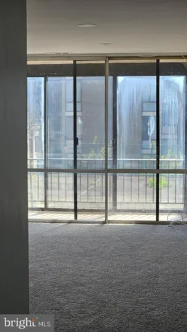 a view of an empty room with a large window