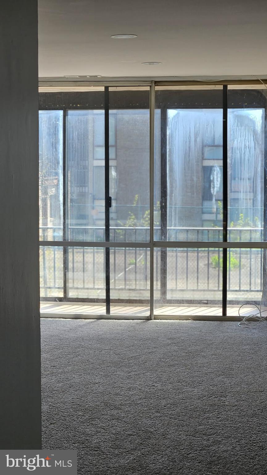 8671 Greenbelt Road, Unit 101 Greenbelt, MD 20770 - Photo 2 of 15 a view of an empty room with a large window
