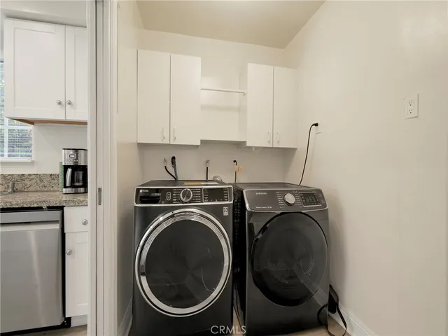 a utility room with sink dryer and washer