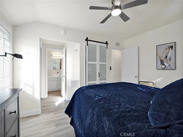 a spacious bedroom with a bed and a chandelier