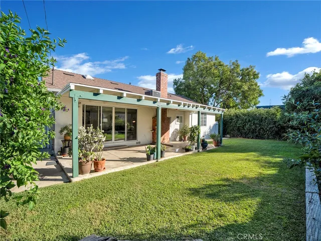 a view of a house with backyard porch and sitting area