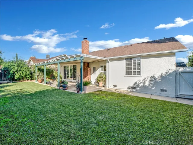 a view of a house with a yard and sitting area