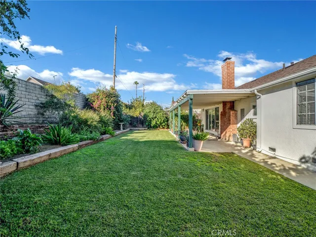 a view of a house with backyard porch and sitting area