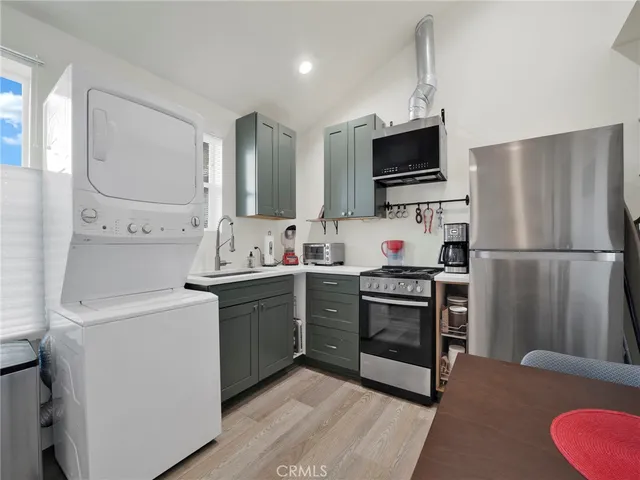 a kitchen with stainless steel appliances a refrigerator stove and sink