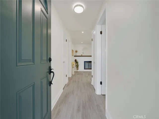 a view of a hallway with wooden floor and staircase
