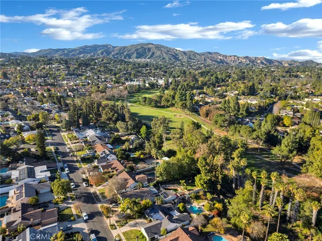an aerial view of residential houses with city view
