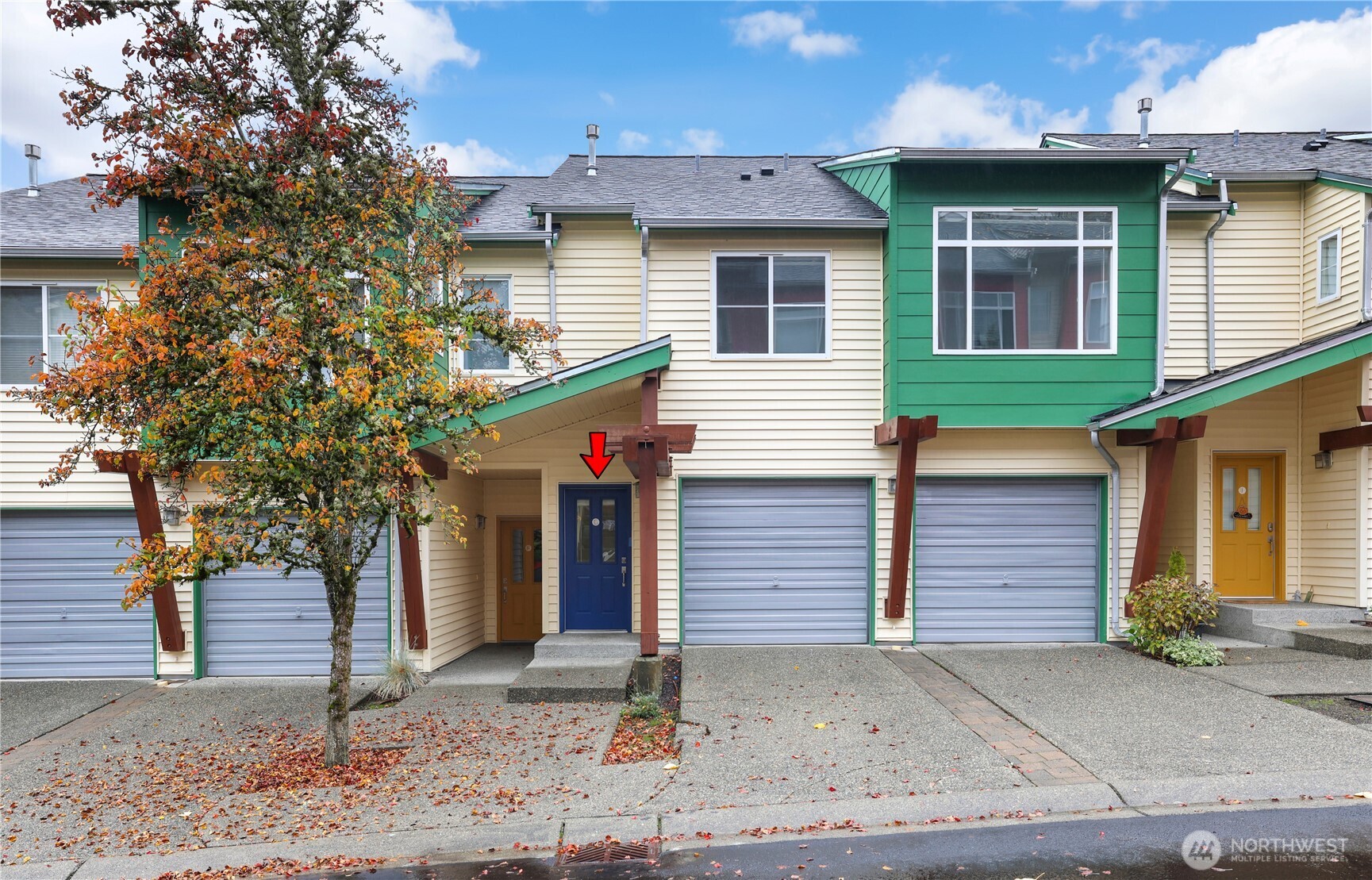a view of a house with a yard and garage