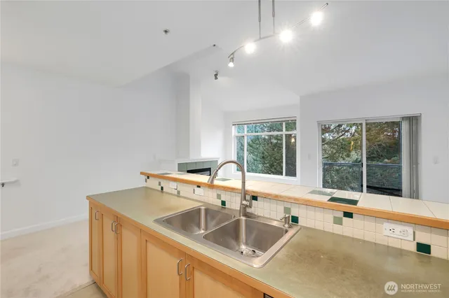 a kitchen with a sink and a large window