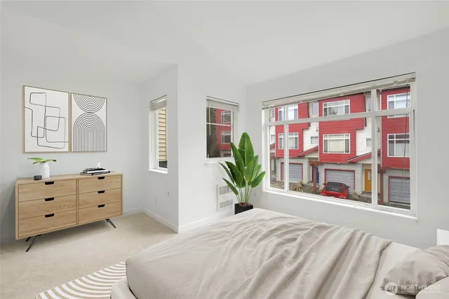 a bedroom with a bed and a large window