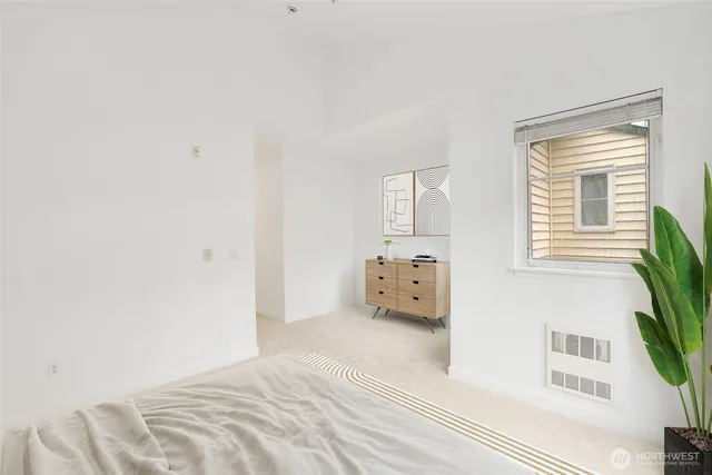 a bed sitting in a bedroom next to a window