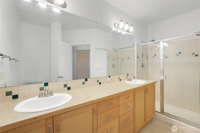 a spacious bathroom with a double vanity sink mirror and double