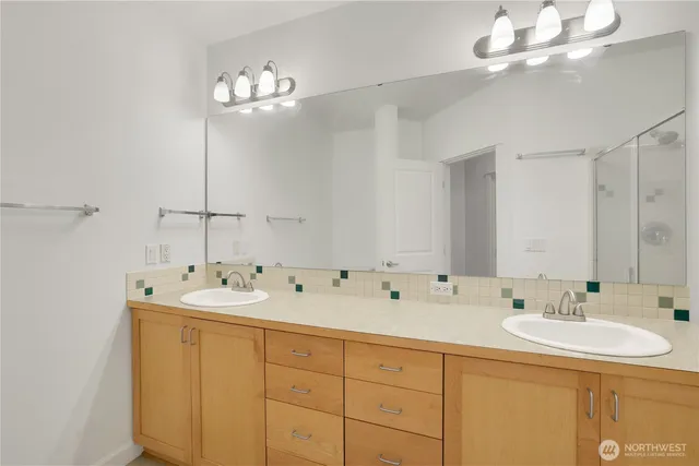 a bathroom with a sink a mirror and a light fixture